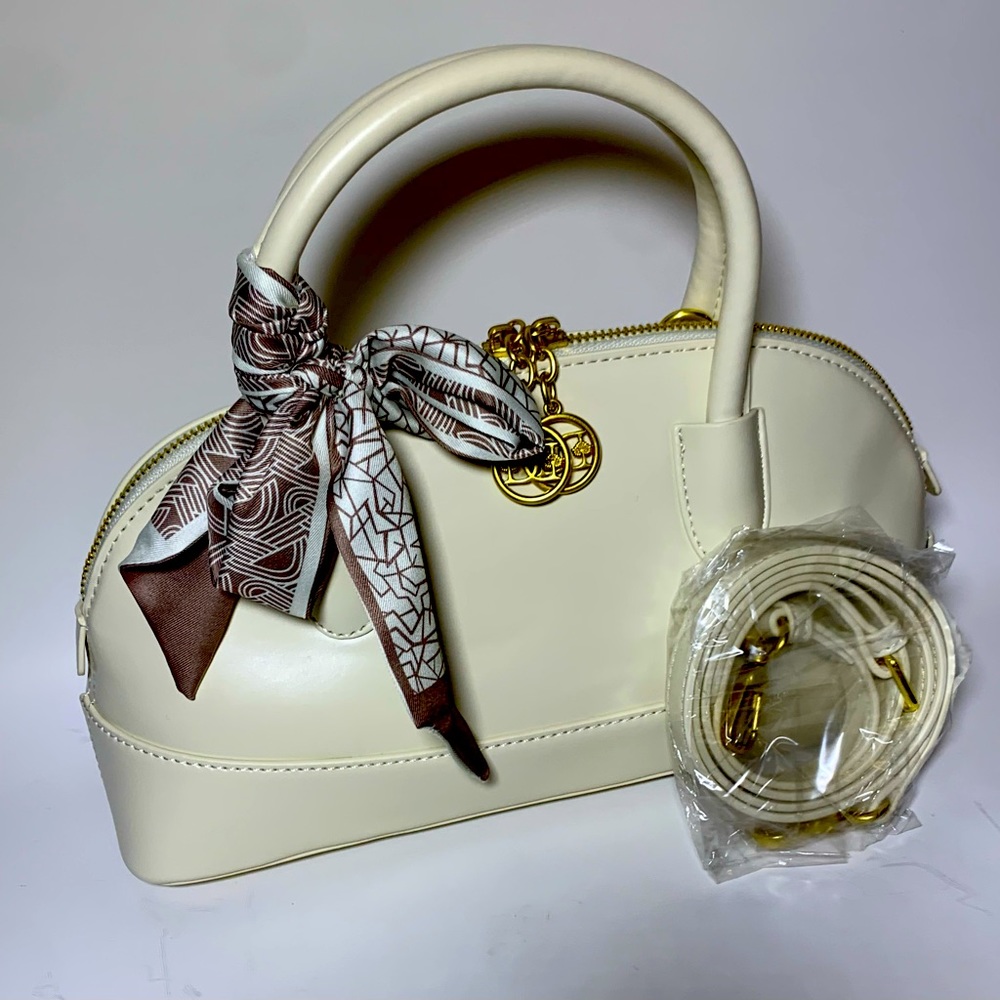 Cream colored handbag with scarf.